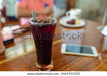 Black coffee, reception table, relaxation with food and drinks, focus on the glass and blur the background