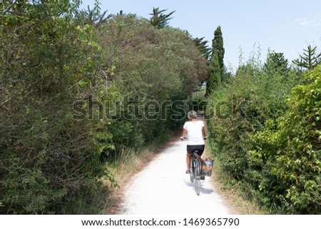 tourist woman bike ride in ile d'Aix Charente maritime France