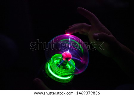 Ball with electric discharges. Lump with plasma inside photographed in the dark. Beautiful flashes of electricity.