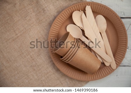 Disposable tableware from natural materials, wooden knife, spoon, fork, environmentally friendly. Ecological dishes in nature. Place for text.
