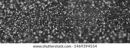 Silver decorative sequins. Background image with shiny bokeh lights from small elements