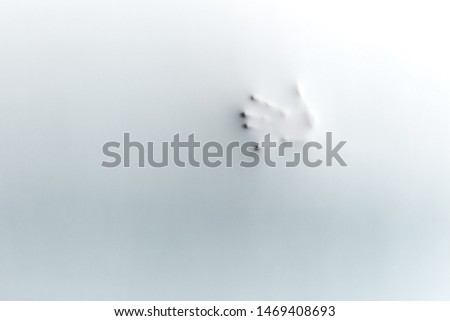 woman's hand behind the polyethylene. copy space.touching the void. fear, terror,woman expresses alarm. horror film. shadow blur of ghost's hand. copy space. madness
