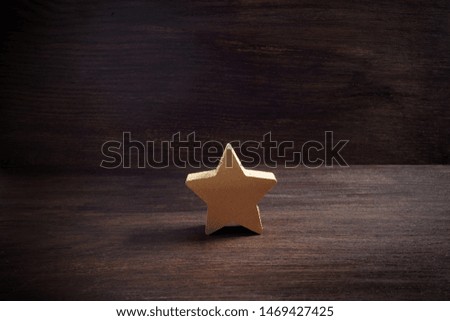 golden stars on dark wooden background, top rating concept