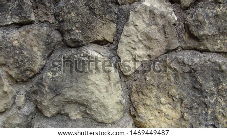 texture and background of the wall lined with large stones