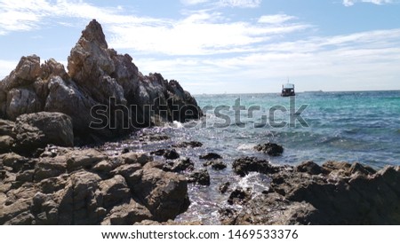 image of rocks with the background of blue sea