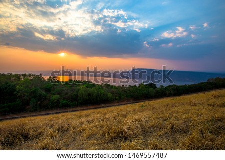 The natural background of mountain scenery, can be seen (rivers, grasslands, roads) and has a secret light, beautiful orange sky as the season, blown through the blur.