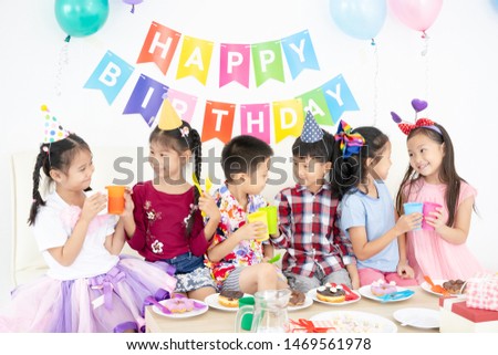 Group of asian kids drinking juice at birthday party