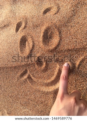 Hand Drawing a Beautiful Cute Smile in Desert Sand - Background