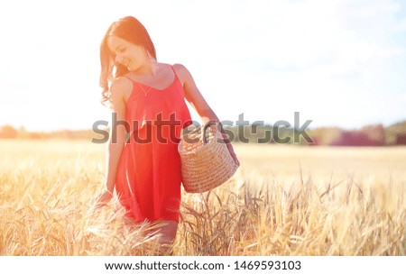Young girl in a wheat field. Summer landscape and a girl on a nature walk in the countryside. Rest in the village.
