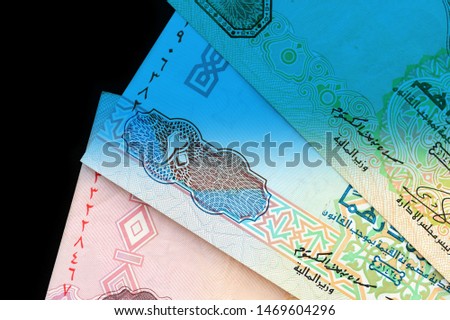 UAE dirham currency notes close up. Money background blue color toned