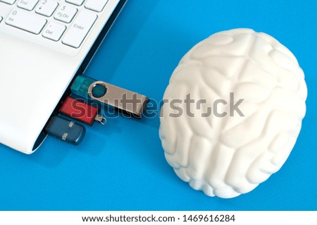 three memory cards in the laptop. human brain. the concept of artificial intelligence