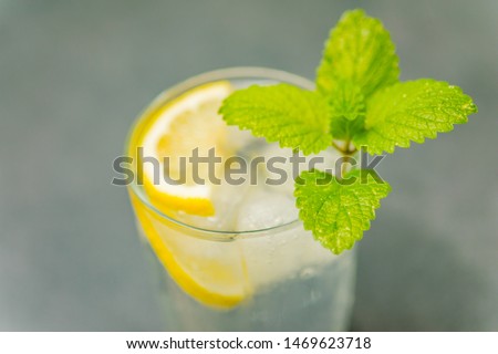 Delicious cold drink. Glass with ice cubes. Fresh icy cold cool freshening liquid. Beautiful background.