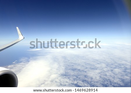 wing of an airplane flying above the clouds
