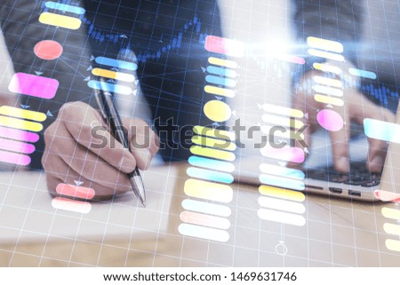 Close up of hands using laptop and writing at workplace with abstract programming interface. Artificial intelligence and software concept. Double exposure 