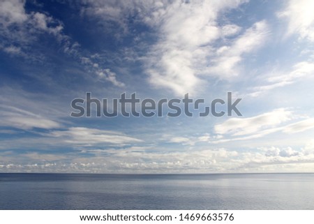 Great blue sky over expansive clear blue ocean - epic sweeping shot of ocean sea and sky horizon Royalty-Free Stock Photo #1469663576