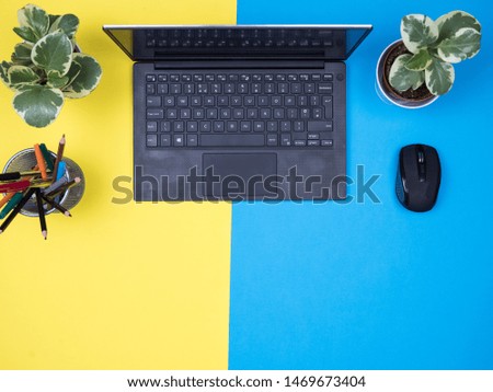 Flat lay top view of modern notebook over blue background. Copy space available.