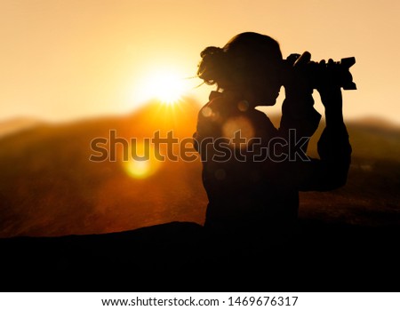 Female Photographer at sunrise in the mountains