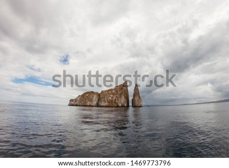 Beautiful view of "Kicker Rock" island, off the coast of San Cristobal, Galapagos. View of rock and ocean horizon. Famous diving and snorkel site. Hammerhead sharks, seals, turtles, wildlife. 2019