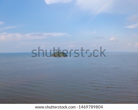 Aerial view landscape of sea beach.Scenery consist of blue sea,Waves moving towards the shore,blue sky with cloud, fisherman village along the bay at Chantaburi,Thailand. 