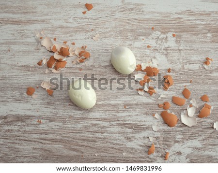 peeled boiled eggs on a wooden background