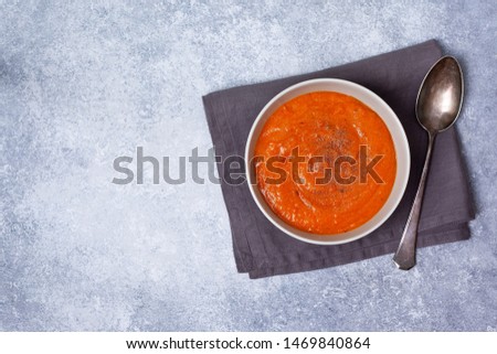 vegetable soup in a white bowl on a gray background. view from above