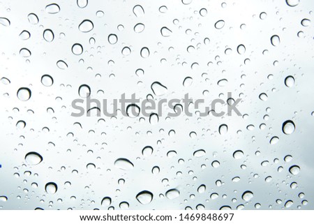 Tiny rain drops on glass