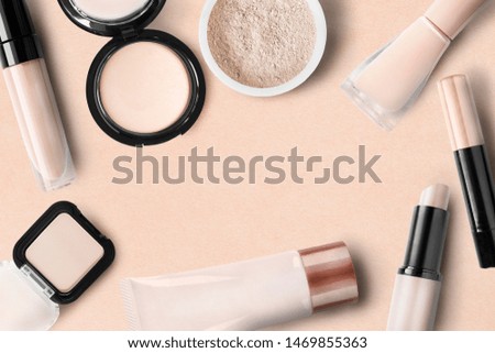Collection of beige colored cosmetics on beige background
