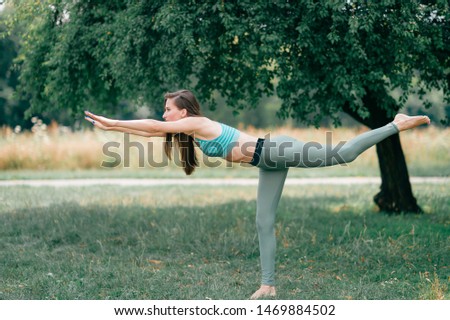 Brunette fitness girl doing yoga outdoor