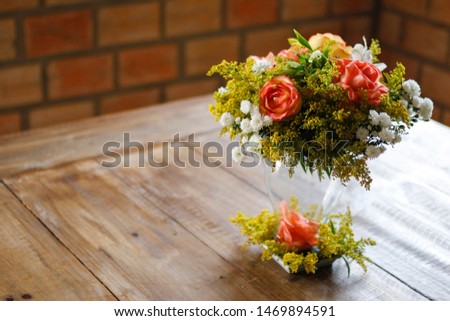 Floral arrangement on wood table, wood textured surface, neutral space, wood textured flower arrangement