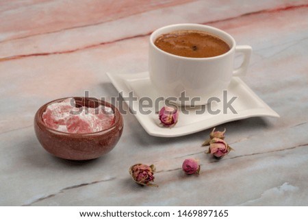 Turkish delight and coffee on a table decorated with roses