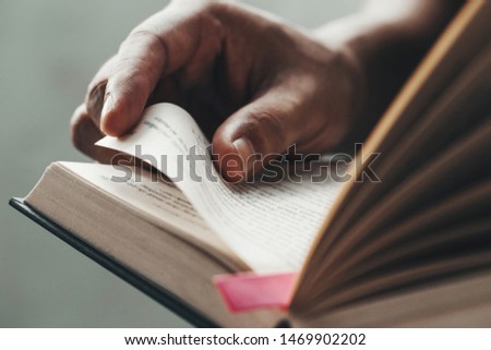 Close up man hands.Young man opening and reading a book, 
