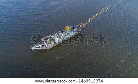 Aerial view of big fishing trawler boat in ocean  with two small boats , drone shot , 