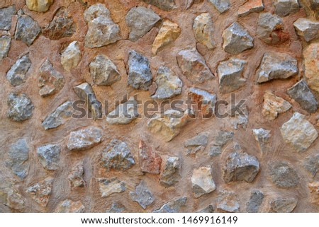 Old exterior stone wall texture background. Ancient brickwork. Texture from Mallorca.