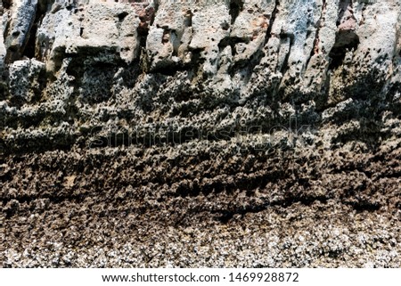Thailand island rock texture. There are  rugged stones and brown stripes.
