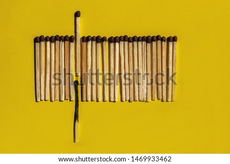 There are no irreplaceable people in this world concept. The burned wooden match stick is quickly replaced by a new one on yellow background. Royalty-Free Stock Photo #1469933462