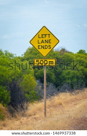 Left lane ends in 500 meters street sign next to australian road