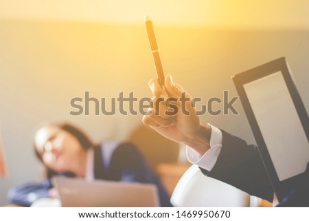 Businessmen use pens to sign company documents.