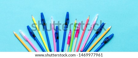 Flat lay top view, set of school supplies notebook pens pencils for study, school blue background