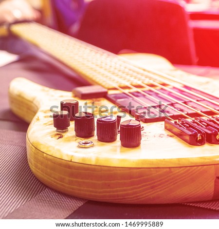 Modern Electric six-string bass guitar. Toned photo. Selective focus