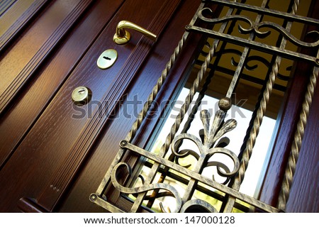 wooden door with forged metal grate 