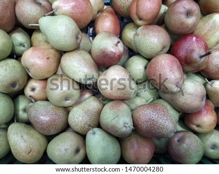 Large group of green and red pears background. Close-up