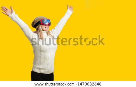 Woman Skier Standing at Snow Looking . Winter yellow, orange, background