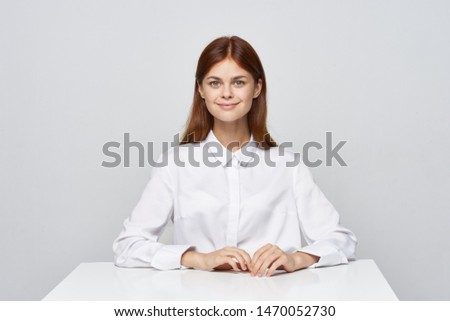    woman in a white shirt on a light background                            