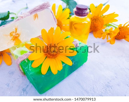 soap, calendula flower oil on a gray concrete background