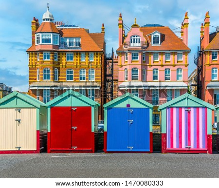 Brightly coloured beach huts adorn the promenade in Hove, UK in summertime Royalty-Free Stock Photo #1470080333