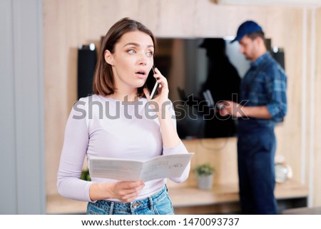 Young woman onsulting household repair service on the phone Royalty-Free Stock Photo #1470093737