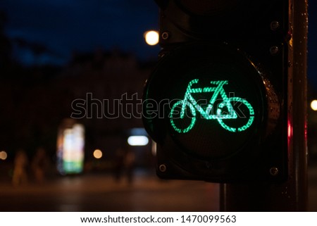 Sustainable transport. Night bicycle traffic signal, green light, road bike, free bike zone or area, bike sharing