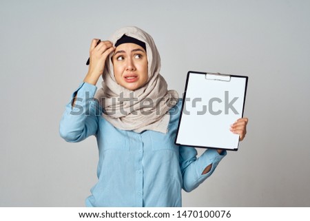 woman in a burqa with documents in her hands                               
