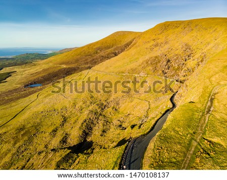 Aerial view of Conor Pass, one of the highest Irish mountain passes served by an asphalted road, located on the south-western end of the Dingle Peninsula, County Kerry, Ireland Royalty-Free Stock Photo #1470108137