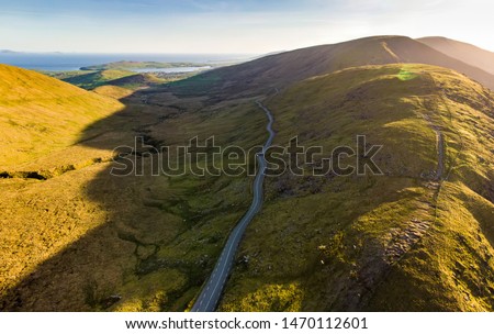 Aerial view of Conor Pass, one of the highest Irish mountain passes served by an asphalted road, located on the south-western end of the Dingle Peninsula, County Kerry, Ireland Royalty-Free Stock Photo #1470112601